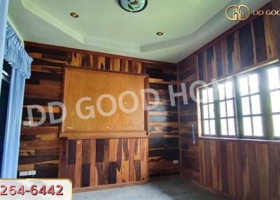 Bedroom with wooden paneling and large window