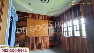 Bedroom with wooden paneling and large window