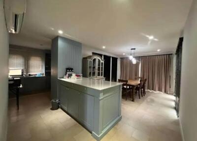 Spacious kitchen and dining area with island and modern lighting