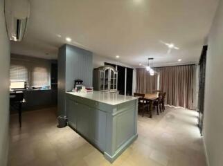 Spacious kitchen and dining area with island and modern lighting