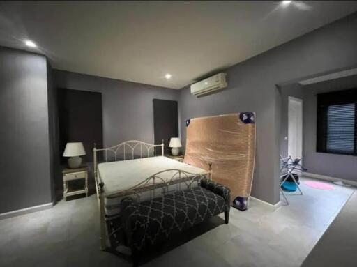 Modern unfurnished bedroom with air conditioning and ample lighting