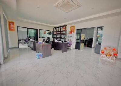 Spacious office area with desks and storage shelves