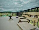 Outdoor balcony with wooden chairs and scenic view