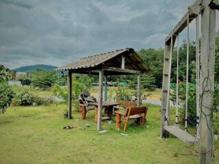 Outdoor garden area with seating and a swing