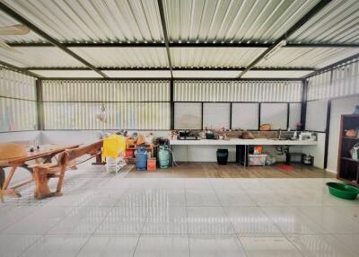 Spacious outdoor kitchen with corrugated metal roof