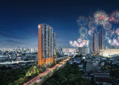 Night view of a cityscape with a tall residential building and fireworks in the sky