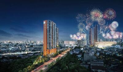 Night view of a cityscape with a tall residential building and fireworks in the sky