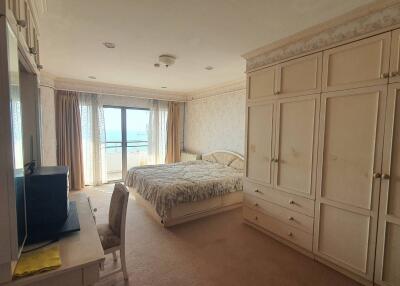 Spacious bedroom with large window and ample storage
