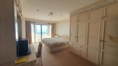 Spacious bedroom with large window and ample storage