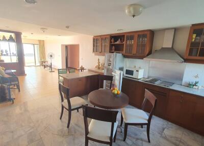 Modern kitchen and dining area with a view of the living room