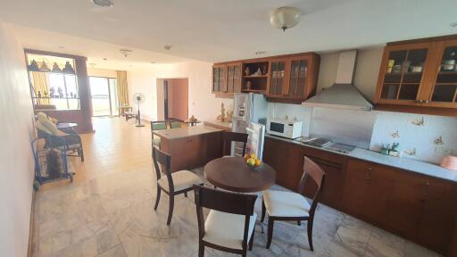 Modern kitchen and dining area with a view of the living room