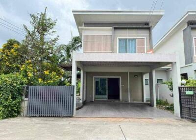 Two-story modern house with gated driveway and garden