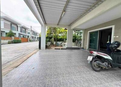 Covered carport with adjacent garden area