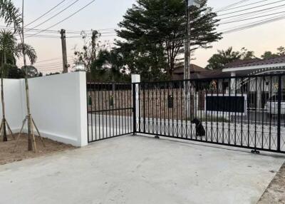 Gated driveway with view of front entrance and street