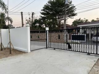 Gated driveway with view of front entrance and street