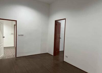 Minimalist room with wooden floor and two doorways