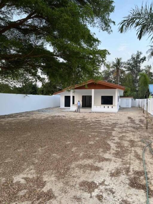 Single-story house with spacious yard and mature trees