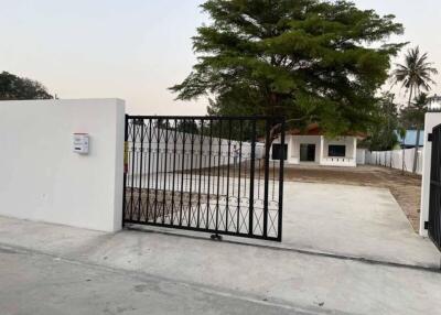 Gated entrance with driveway and tree