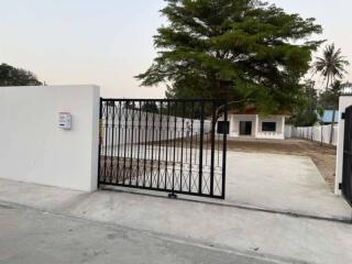 Gated entrance with driveway and tree