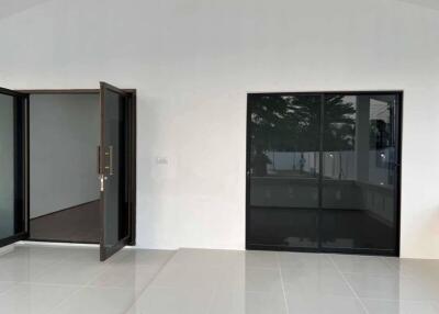 Spacious living room with large sliding glass doors and an additional door