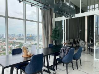 Modern dining area with large windows and city view