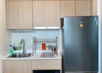 Modern kitchen with wooden cabinets and stainless steel appliances