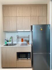 Modern kitchen with wooden cabinets and stainless steel appliances