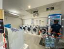 Laundry room with washing machines, water dispenser, and customer