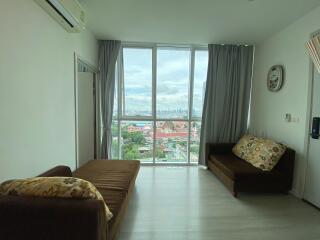 Bright living room with large window and city view