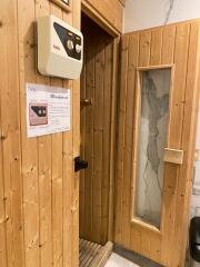 Wooden sauna room with control panel