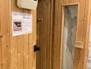 Wooden sauna room with control panel