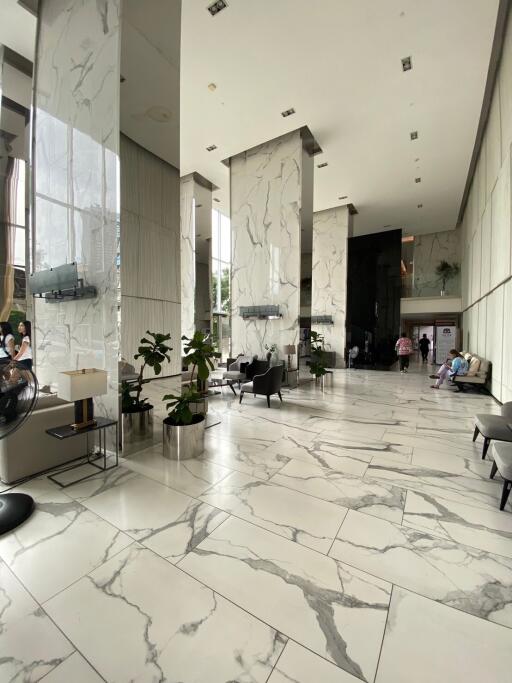 Modern building lobby with high ceilings and marble flooring