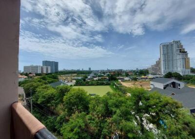 Scenic balcony view with lush greenery and city skyline