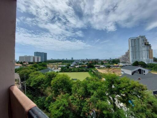 Scenic balcony view with lush greenery and city skyline