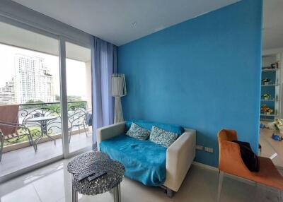 Cozy living area with a blue accent wall and access to a balcony