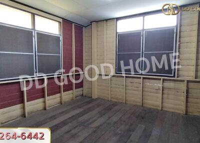 Unfurnished room with large windows and wooden flooring