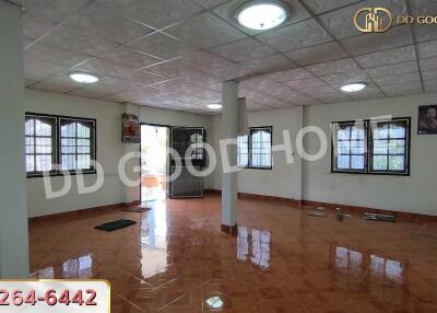 Spacious main living area with glossy tiled floors and multiple windows