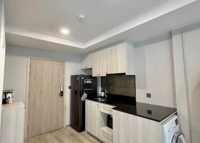 Modern kitchen with appliances and light wood cabinetry