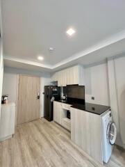 Modern kitchen with appliances and light wood cabinetry