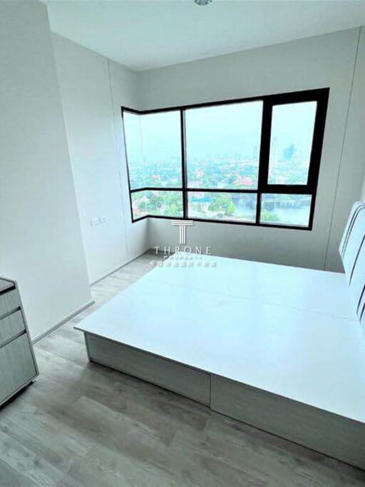 A bright bedroom with a city view