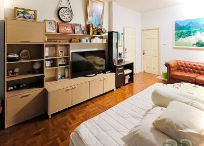 Spacious living room with wooden flooring and a cozy sofa