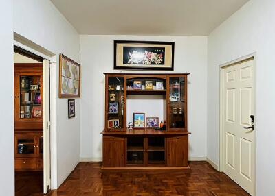 Living room with wooden cabinet and parquet flooring