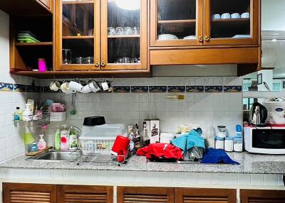 Kitchen with wooden cabinets, counter space, and various appliances