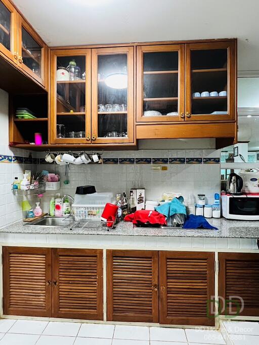 Kitchen with wooden cabinets, counter space, and various appliances