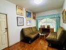 Cozy living room with framed art and green sofas