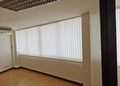 Room with large window and blinds