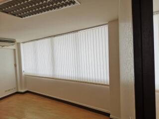 Room with large window and blinds