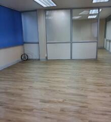 Open area office with wooden floors and partition walls