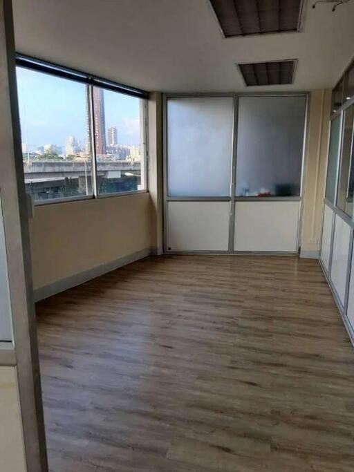 empty room with large windows and wood flooring