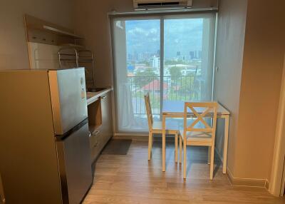 Compact kitchen and dining area with city view